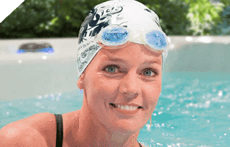 Woman swimming with swim cap in an h2x swimspa